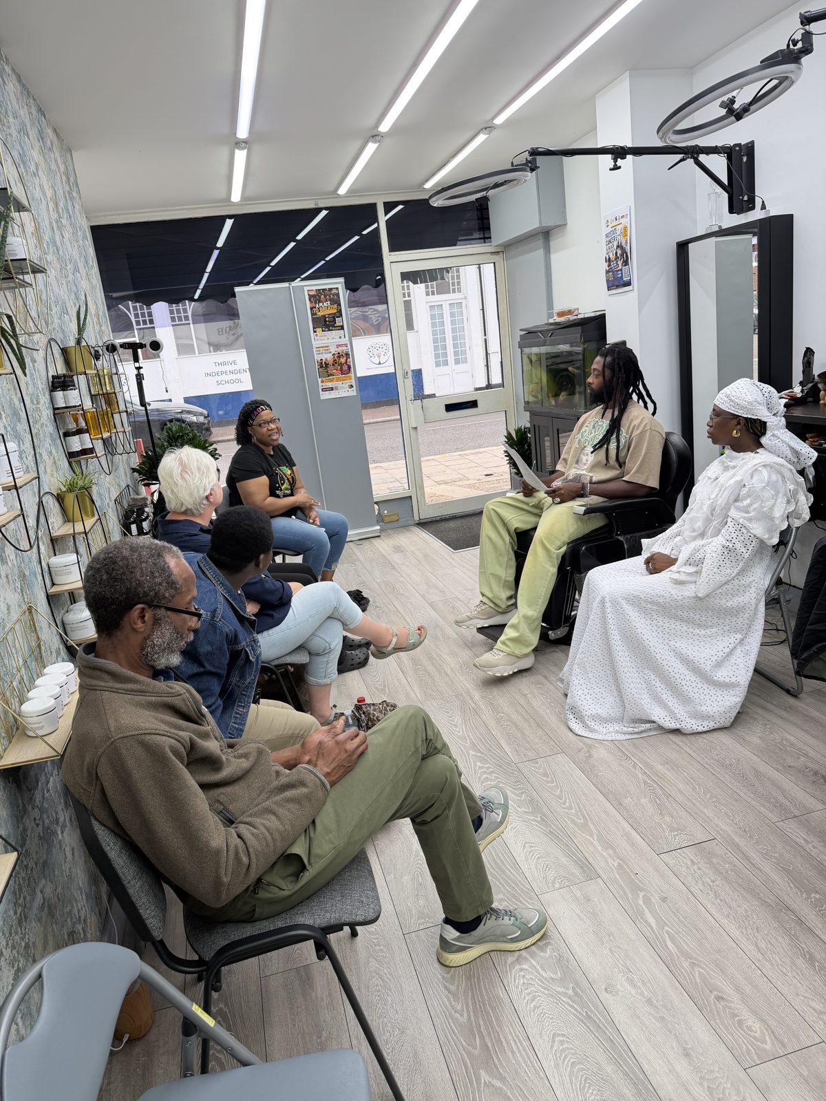 A facilitator speaking with parents and carers at A Place to Breathe in Nick's HQ Barbershop